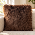 coffee long-pile faux fur pillow cover on a beige sofa beside a bright window.