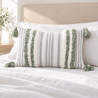 Green and cream white 20x12 lumbar tufted pillow cover on a white bed with beige headboard.