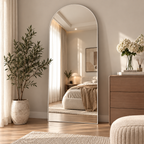 A cozy modern bedroom interior featuring an oversized arched full length floor mirror by HavvakHome.