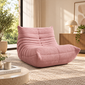 A cozy modern living room interior featuring a dusty pink bouclé lounge chair by HavvakHome.