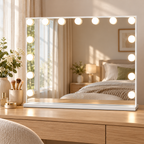 White rectangular vanity mirror with 15 lighted bulbs set on a light-oak bedroom vanity table.