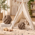 HavvakHome taupe knot ball pillows styled near a cream teepee play tent on a plush rug in a nursery.