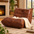 Brown button-tufted armless floor lounge chair with a cream knitted throw on a rug beside a fireplace, shelves, and a window by HavvakHome.