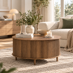 Round walnut-tone fluted coffee table with short legs styled with books, a leafy vase, bowl, and candle in front of a cream sofa by HavvakHome.