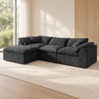 Charcoal gray modular sectional sofa with left chaise and matching pillows on a neutral rug.