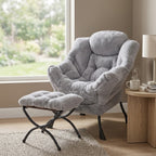 Light gray fuzzy plush lounge chair and matching padded ottoman with black legs, wood side table with a steaming mug, and a lamp by a window by HavvakHome.