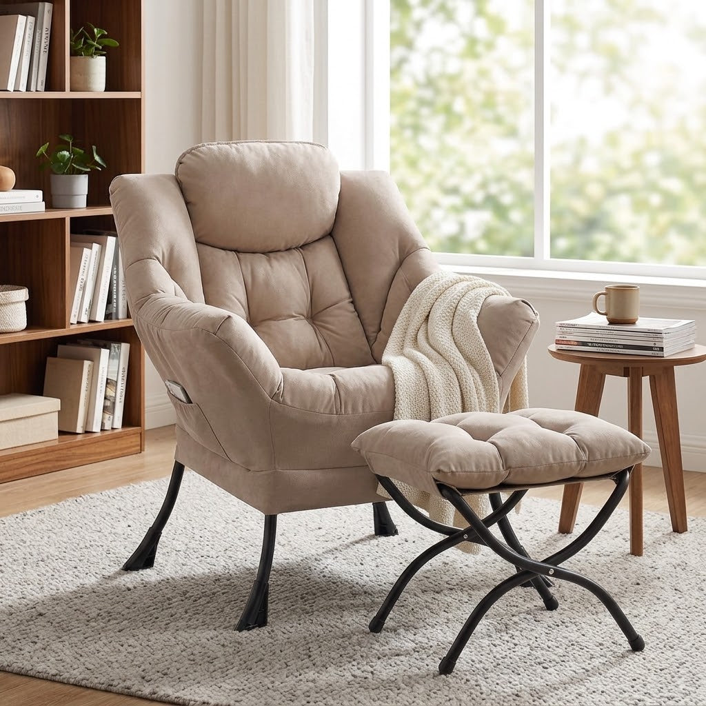 Taupe padded lounge chair with matching foldable ottoman, black metal legs, cream throw, bookshelf, and wooden side table by a window by HavvakHome.