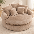Beige round boucle cuddle chair with five matching pillows and rounded arms in a sunlit room by HavvakHome.