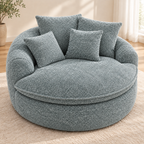 Blue-gray round boucle cuddle chair with four matching pillows, rounded arms, and a thick round seat cushion by HavvakHome.