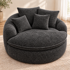 Charcoal gray round boucle cuddle chair with four matching pillows, rounded arms, and a round seat cushion by HavvakHome.