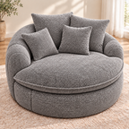 Gray oversized round boucle cuddle chair with four matching pillows, rounded arms, and a round seat cushion in a bright room by HavvakHome.