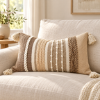 Brown 20x12 inch lumbar pillow cover with vertical textured stripes and corner tassels displayed on an oatmeal linen sofa.