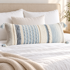 Coastal blue 36x14 inch extra-long lumbar pillow cover showing vertical textured stripes and tassels on a white bed.