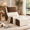 Cream and brown two-tone corduroy armless lounge chair with matching ottoman, brown pillow, and cream knit throw beside a window by HavvakHome.